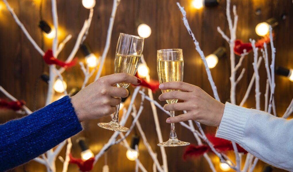 person holding wine glasses with red liquid